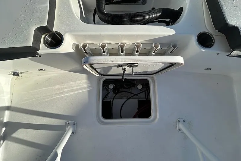 Slide: The Image of 2026 Sea Pro 202 Center Console boat interior with rod holders and storage compartment. - 18
