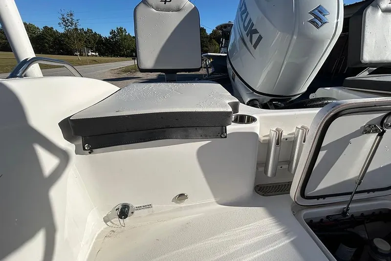 Slide: The Image of 2026 Sea Pro 202 Center Console boat interior with Suzuki engine and seating area. - 19