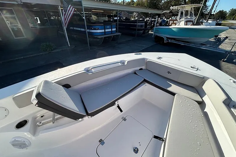 Slide: The Image of 2026 Sea Pro 202 Center Console boat interior with seating and storage, displayed outdoors. - 22