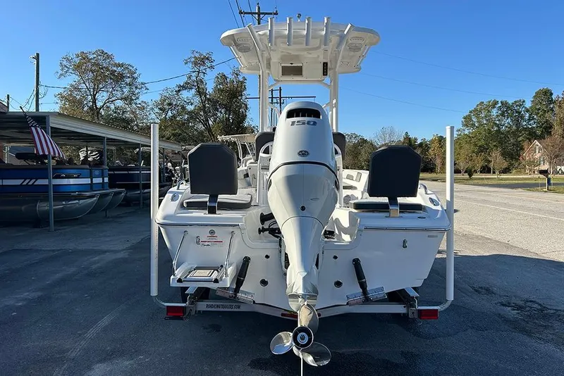 Slide: The Image of 2026 Sea Pro 202 Center Console boat with powerful outboard motor, parked outdoors. - 3