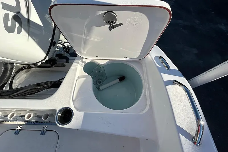 Slide: The Image of 2026 Sea Pro 202 Center Console boat with open storage compartment and visible engine. - 35