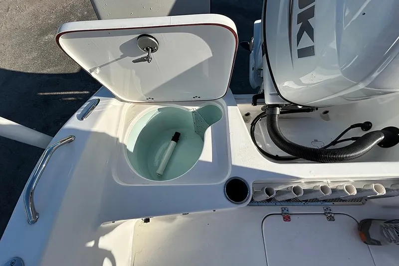 Slide: The Image of 2026 Sea Pro 202 Center Console boat with open storage compartment and Suzuki engine. - 36