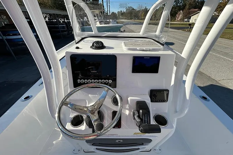 Slide: The Image of 2026 Sea Pro 202 Center Console boat dashboard with steering wheel and navigation controls. - 37