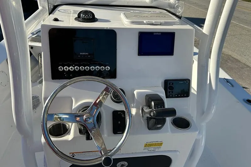 Slide: The Image of 2026 Sea Pro 202 Center Console boat dashboard with steering wheel and controls. - 38