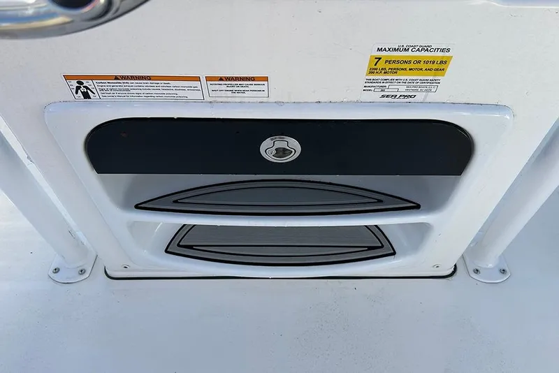 Slide: The Image of 2026 Sea Pro 202 Center Console storage compartment with capacity warning labels. - 39