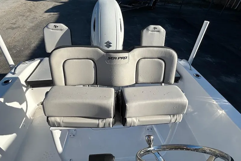 Slide: The Image of 2026 Sea Pro 202 Center Console boat interior with cushioned seating and steering wheel. - 42