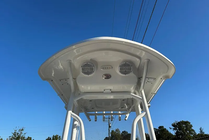 Slide: The Image of 2026 Sea Pro 202 Center Console boat with T-top and speakers against blue sky. - 49