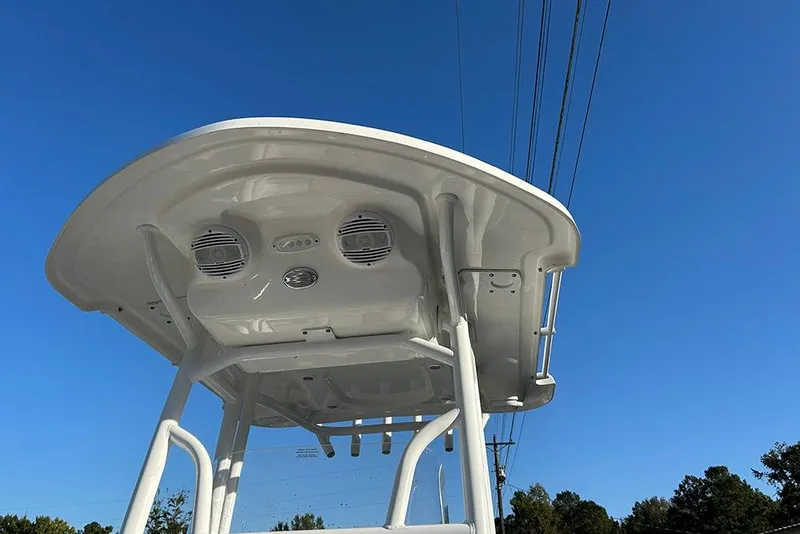 Slide: The Image of 2026 Sea Pro 202 Center Console boat with speakers, viewed from below against blue sky. - 51