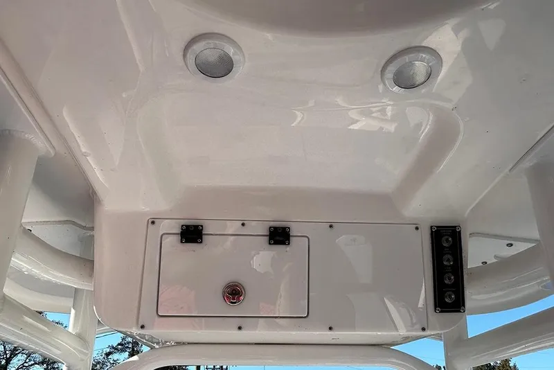 Slide: The Image of 2026 Sea Pro 202 Center Console boat interior with speakers and storage compartment. - 54