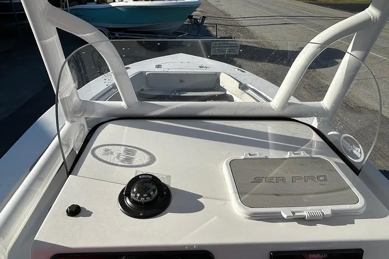 Slide: The Image of 2026 Sea Pro 202 Center Console boat dashboard with compass and windshield. - 56
