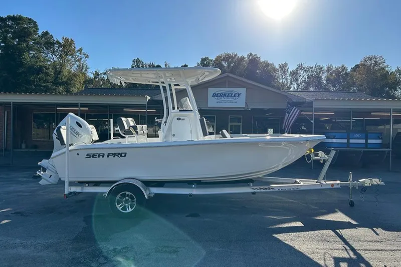 Slide: The Image of 2026 Sea Pro 202 Center Console boat on trailer, parked outside dealership. - 7