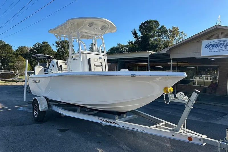 Slide: The Image of 2026 Sea Pro 202 Center Console boat on trailer, parked outdoors. - 9