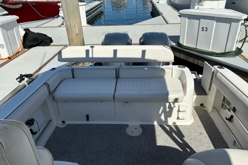 Slide: The Image of 2007 Robalo R265 Walkaround boat interior with seating and dock view. - 6
