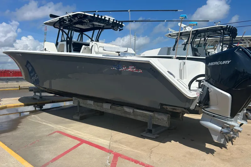 The Image of 2016 SeaHunter 39 Tournament boat with Mercury engines on a dock under a blue sky. - 0