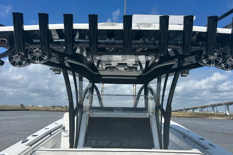 Slide: The Image of 2016 SeaHunter 39 Tournament boat with rod holders and speakers, under a clear blue sky. - 18