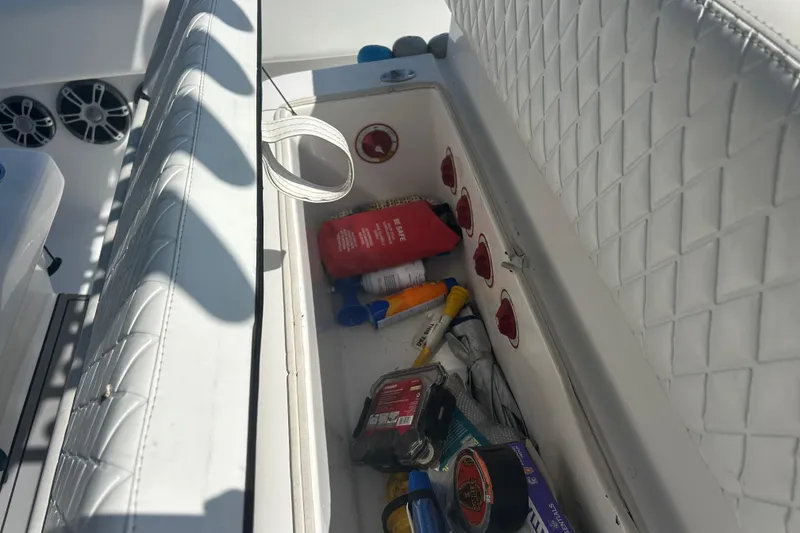 Slide: The Image of Storage compartment on a 2016 SeaHunter 39 Tournament boat with various items inside. - 19