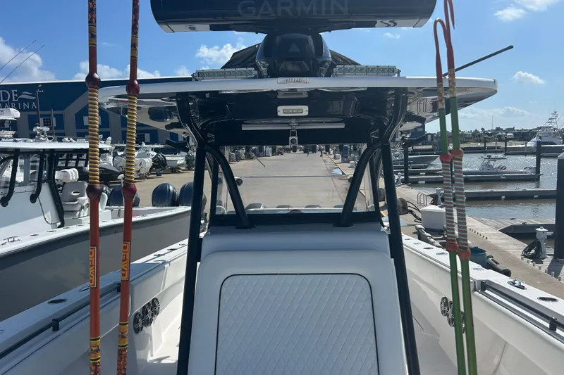 Slide: The Image of 2016 SeaHunter 39 Tournament boat at marina, featuring fishing rods and Garmin equipment. - 26