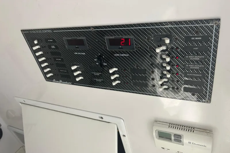 Slide: The Image of Control panel of a 2016 SeaHunter 39 Tournament boat, featuring various switches and displays. - 34