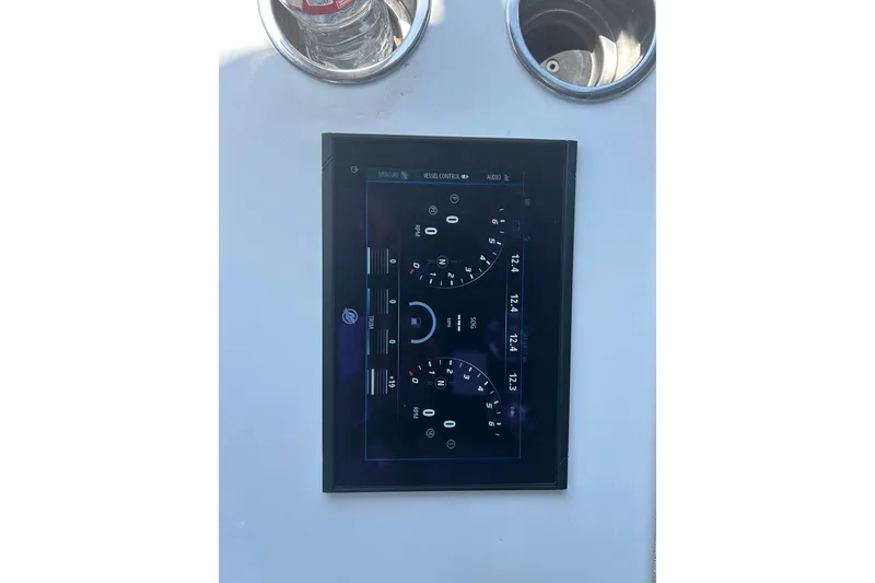 Slide: The Image of Control panel of 2016 SeaHunter 39 Tournament boat with digital display and cup holders. - 38