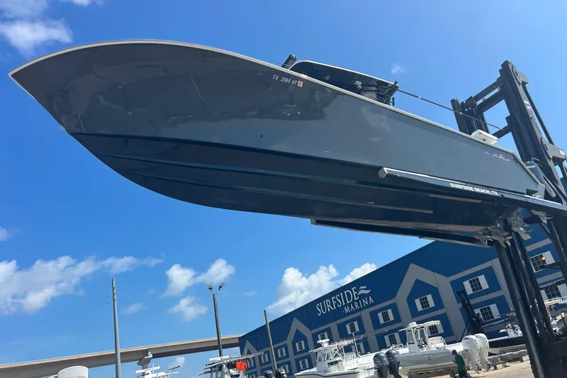Slide: The Image of 2016 SeaHunter 39 Tournament boat lifted at Surfside Marina under clear blue sky. - 4