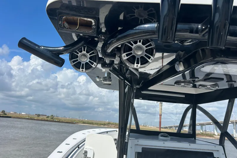 Slide: The Image of 2016 SeaHunter 39 Tournament boat with speakers and rod holders, under a cloudy sky. - 44