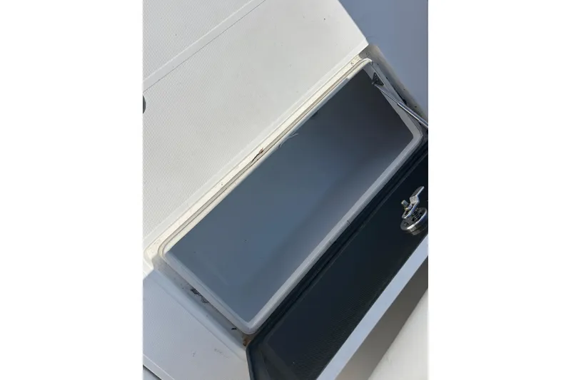 Slide: The Image of Open storage compartment on a 2016 SeaHunter 39 Tournament boat. - 45