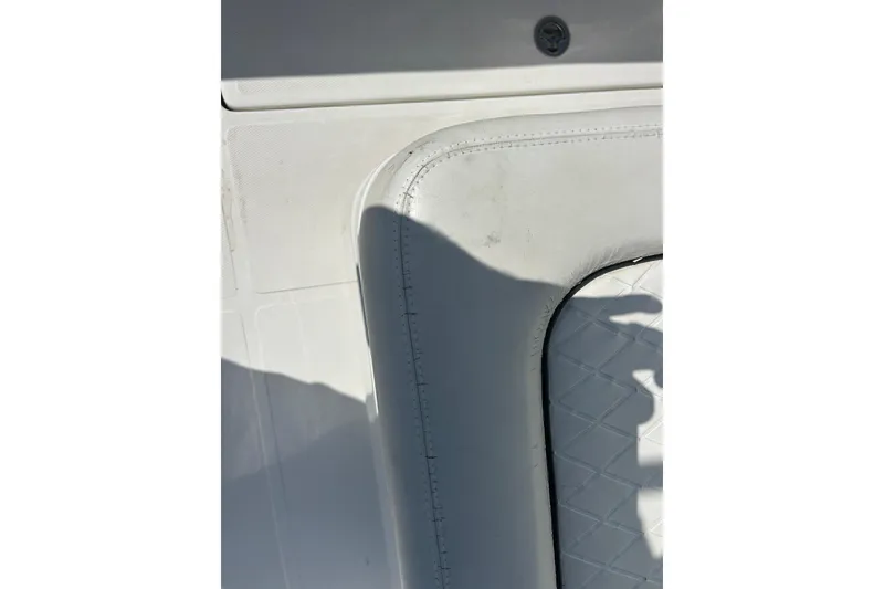 Slide: The Image of White interior detail of a 2016 SeaHunter 39 Tournament boat, featuring cushioned seating. - 47