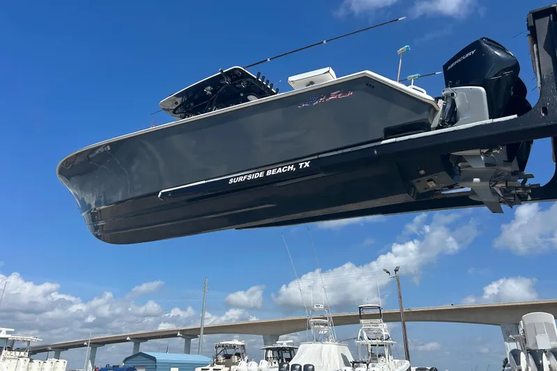 Slide: The Image of 2016 SeaHunter 39 Tournament boat on lift, Surfside Beach, TX, under clear blue sky. - 5
