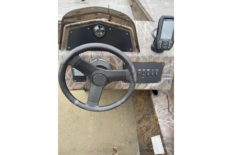 Slide: The Image of 2023 G3 Gator Tough 17 SC boat dashboard with steering wheel and control panel. - 10
