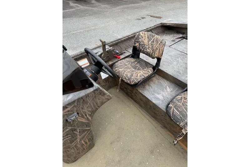 Slide: The Image of 2023 G3 Gator Tough 17 SC boat interior with camouflage seating and steering console. - 11
