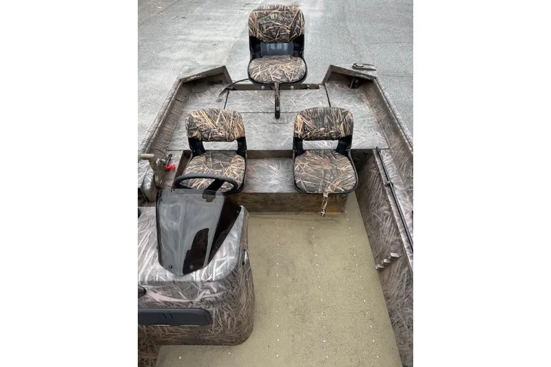 Slide: The Image of 2023 G3 Gator Tough 17 SC boat interior with camo seats and steering console. - 7