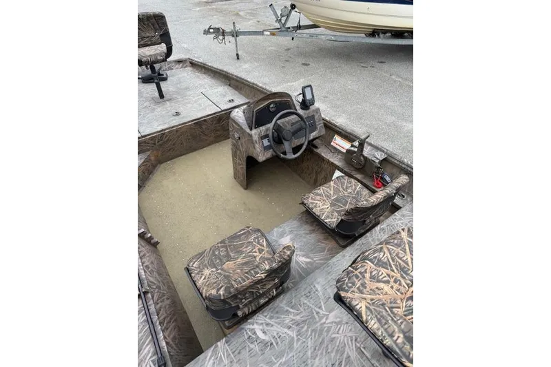 Slide: The Image of 2023 G3 Gator Tough 17 SC boat interior with camouflage seating and steering console. - 8
