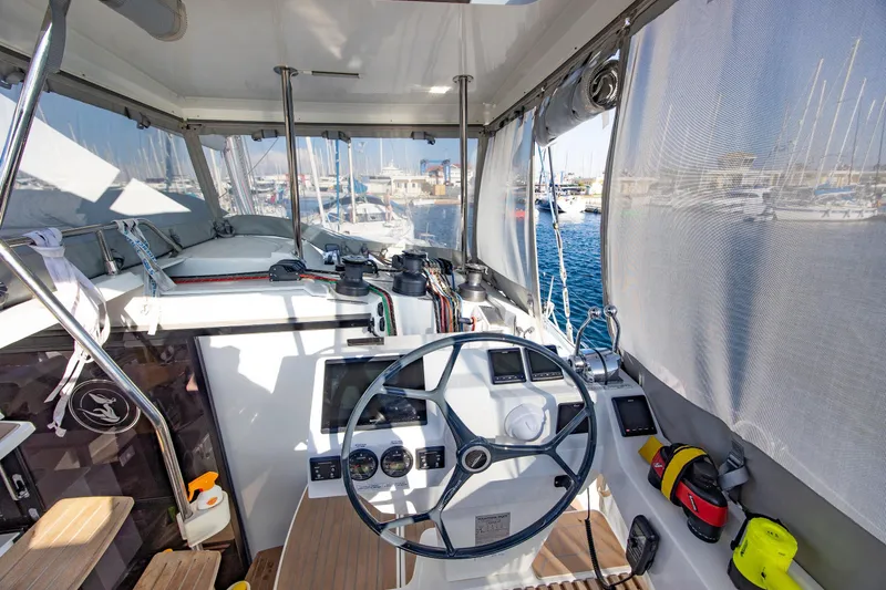 Slide: The Image of 2023 Fountaine Pajot Tanna 47 yacht interior with modern seating and steering wheel. - 14