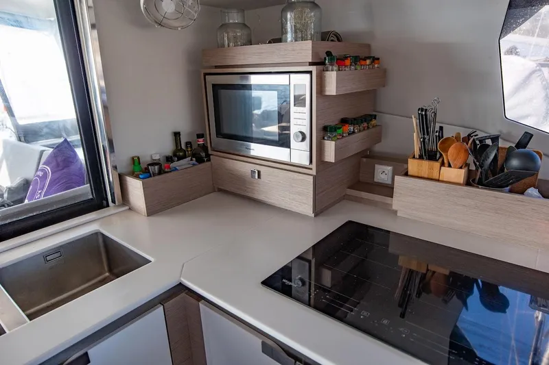 Slide: The Image of Luxurious interior of 2023 Fountaine Pajot Tanna 47 catamaran with modern kitchen and cozy seating. - 29