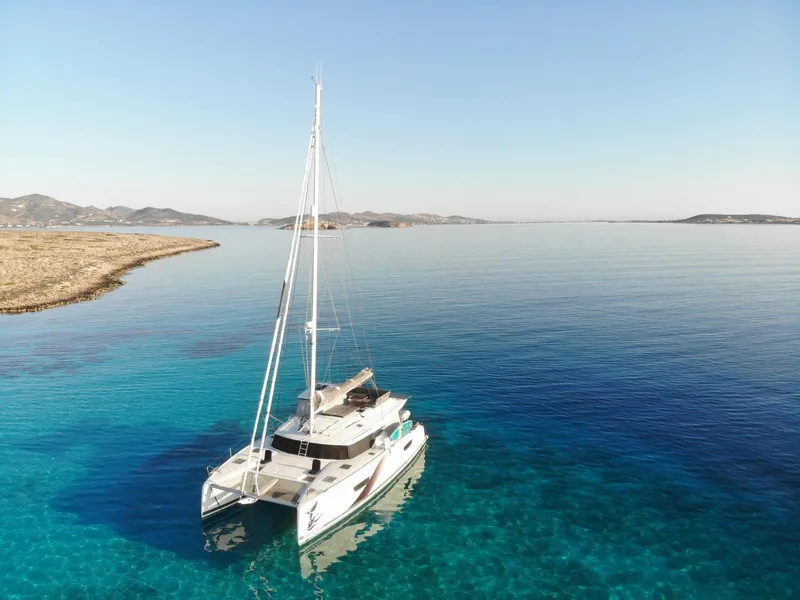 Slide: The Image of 2023 Fountaine Pajot Tanna 47 catamaran sailing in clear blue waters. - 60
