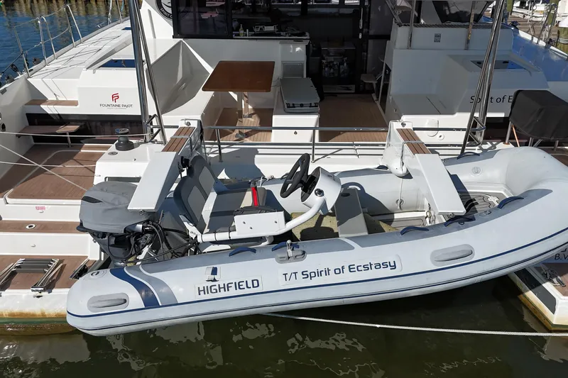 Slide: The Image of 2023 Fountaine Pajot Tanna 47 yacht with Highfield tender docked at marina. - 61