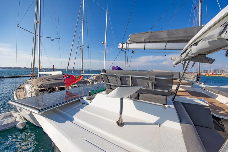 Slide: The Image of 2023 Fountaine Pajot Tanna 47 yacht deck with cushioned seating and table. - 9