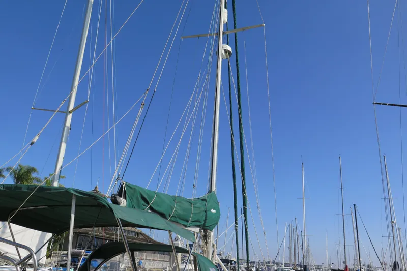 Slide: The Image of 1990 Island Packet 35 sailboat docked in marina, showcasing polished wood trim. - 10