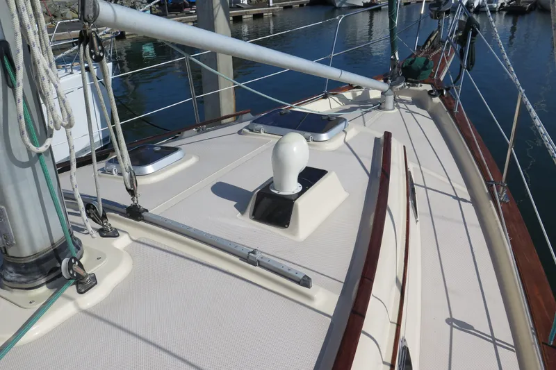 Slide: The Image of Bow of 1990 Island Packet 35 sailboat with anchor and chain over water. - 13