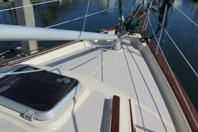 Slide: The Image of Deck view of 1990 Island Packet 35 sailboat, featuring hatch and rigging details. - 14