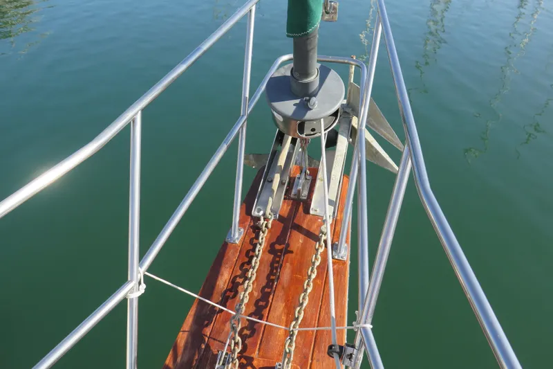 Slide: The Image of 1990 Island Packet 35 sailboat deck view in marina, showcasing rigging and hatches. - 15