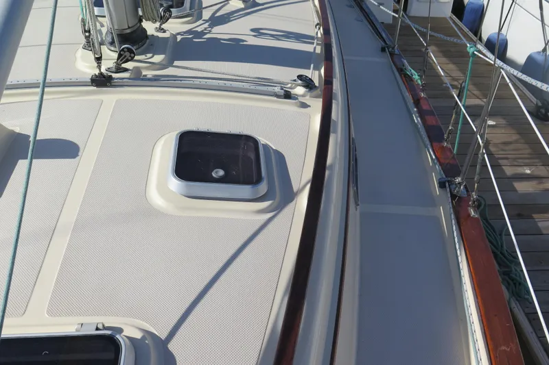 Slide: The Image of 1990 Island Packet 35 sailboat cockpit with steering wheel and seating area. - 17