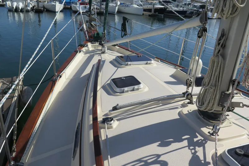 Slide: The Image of 1990 Island Packet 35 sailboat cockpit with steering wheel and seating area. - 18