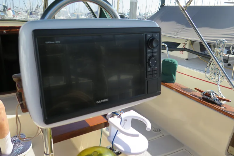 Slide: The Image of 1990 Island Packet 35 sailboat cockpit view in marina setting. - 27