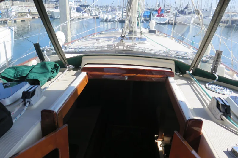 Slide: The Image of Open hatch on 1990 Island Packet 35 sailboat deck, revealing storage compartment. - 30