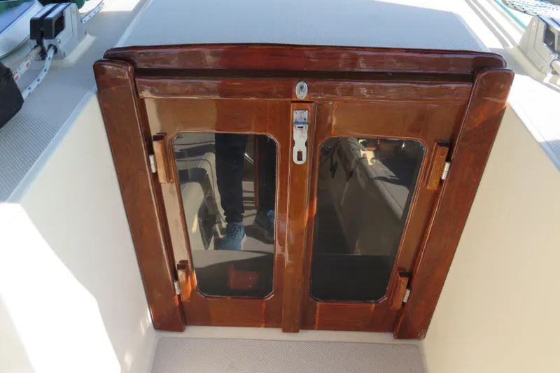 Slide: The Image of Interior of 1990 Island Packet 35 sailboat with cozy seating and wooden accents. - 31