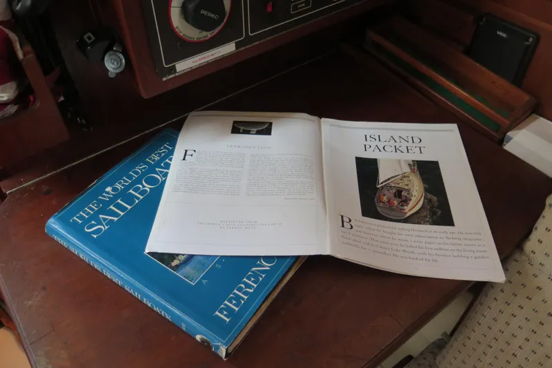 Slide: The Image of 1990 Island Packet 35 interior with wooden cabinets and cushioned seating. - 35