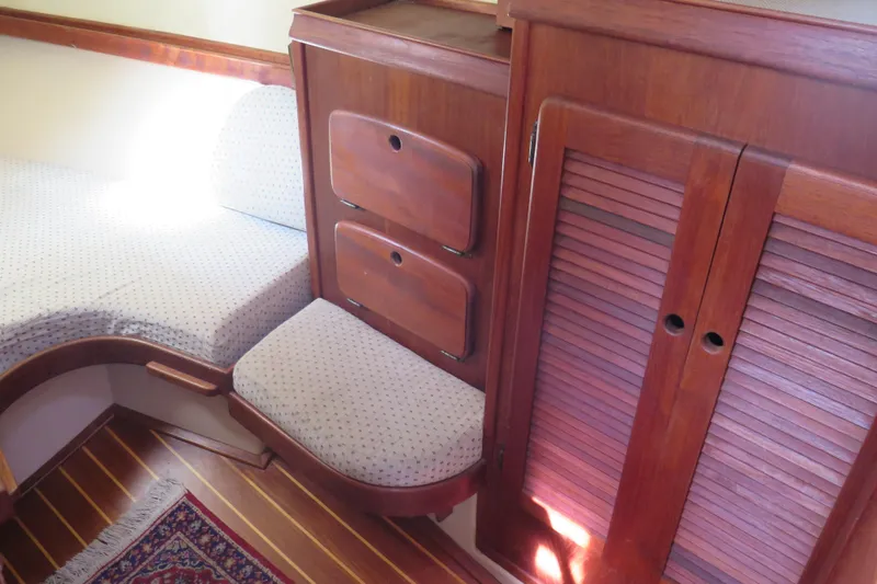 Slide: The Image of 1990 Island Packet 35 interior with cushioned seating, table, and wooden cabinetry. - 38