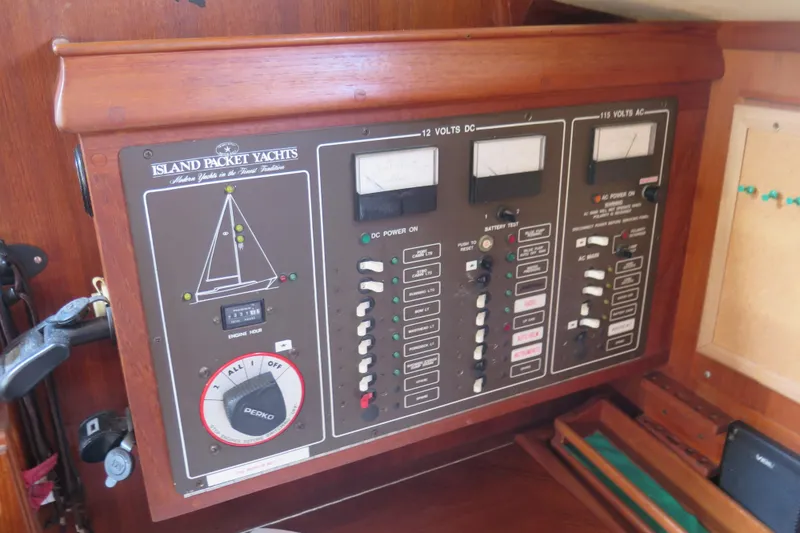 Slide: The Image of Cozy interior of 1990 Island Packet 35 sailboat with cushioned seating and wooden accents. - 39