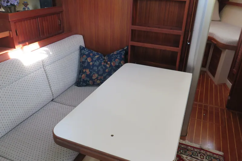 Slide: The Image of 1990 Island Packet 35 yacht shower with wooden seat and handheld showerhead. - 41